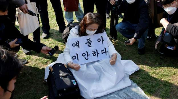 Солонгос эмэгтэй Хотын захиргааны ойролцоох талбайд гашуудаж, уучлалт гуйсан туг барин "хохирогчдыг өрөвдөж байна" гэжээ